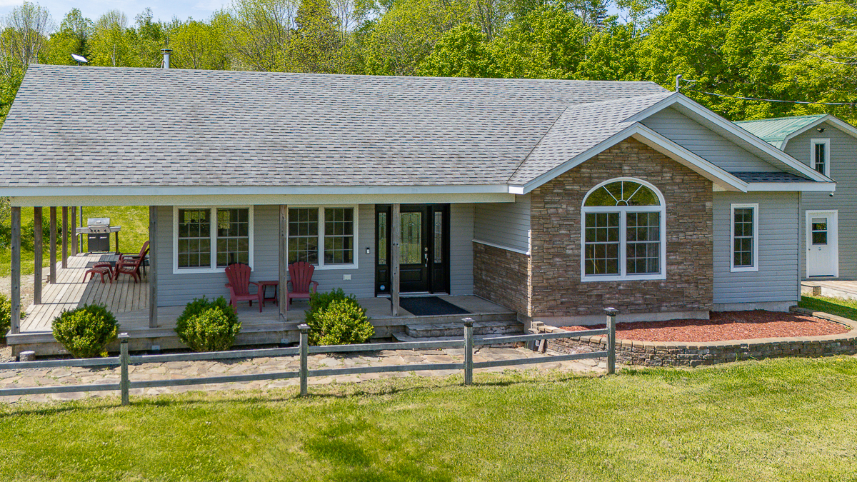 Front of home & verandah | 6800 Route 102, Dumfries, NB E6G 1N9 | Home For Sale with Barn Near Fredericton
